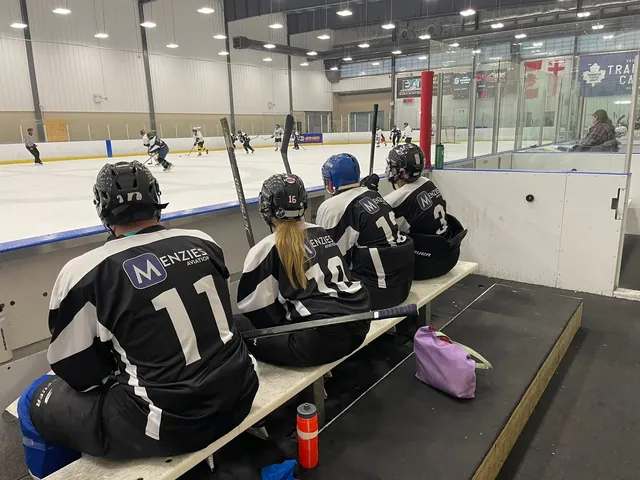 Players sitting on the bench watching the game