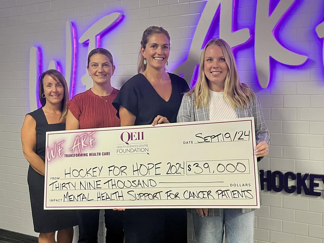 Organizers presenting a cheque for thirty-nine thousand dollars to the QEII Foundation for mental health support for cancer patients