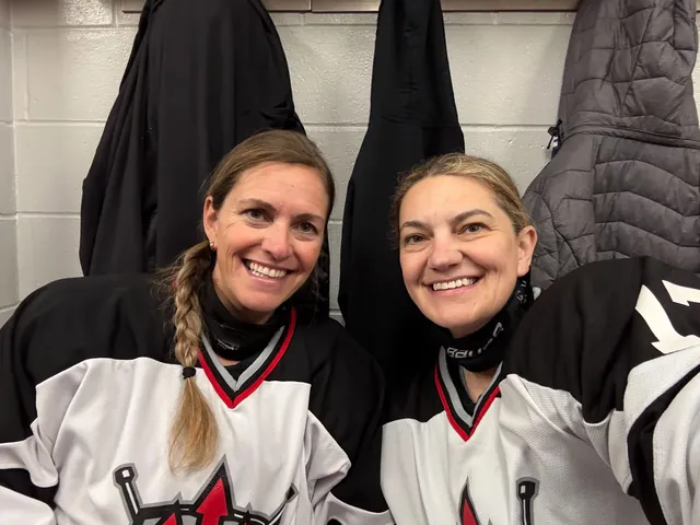 Two players smiling in the dressing room before a game