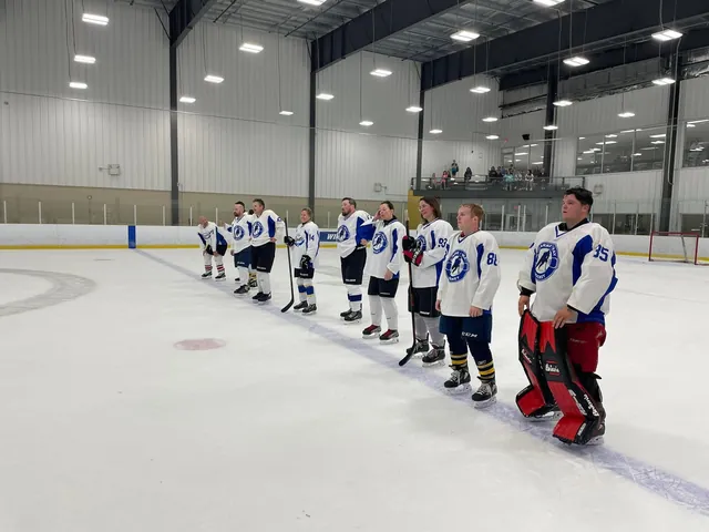 Two teams lining up for handshakes at the end of a game